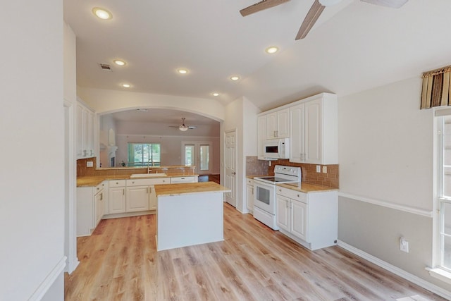 kitchen with white cabinets, white appliances, kitchen peninsula, light wood-type flooring, and ceiling fan