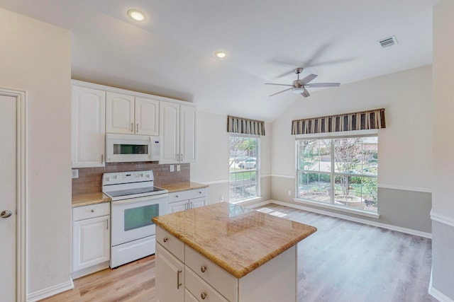 kitchen with light hardwood / wood-style floors, vaulted ceiling, white cabinetry, white appliances, and ceiling fan