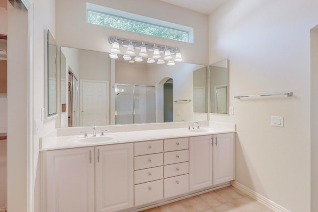 bathroom featuring tile patterned floors, walk in shower, and vanity