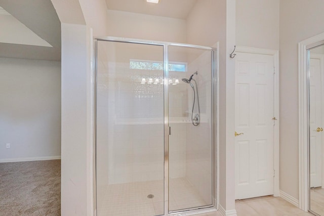 bathroom with tile patterned floors and a shower with shower door