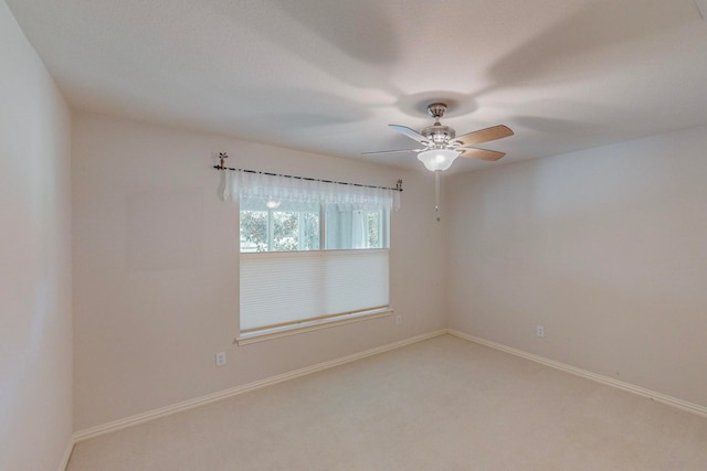 spare room featuring carpet flooring and ceiling fan