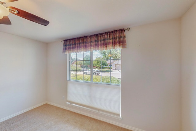 unfurnished room with ceiling fan and carpet floors