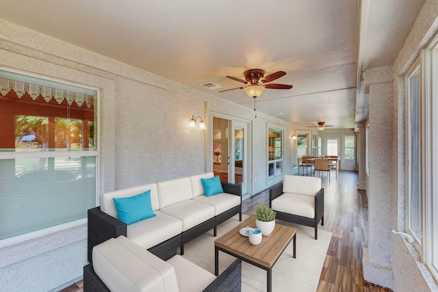 sunroom / solarium with ceiling fan