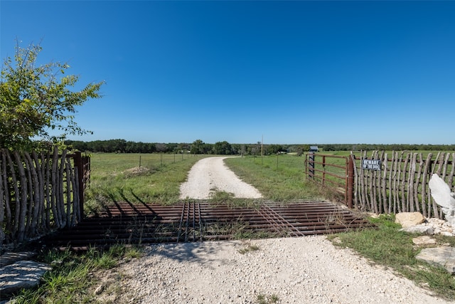 view of gate with a rural view