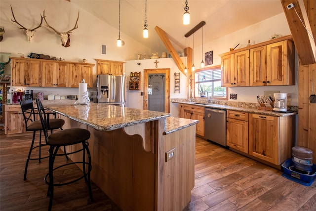 1204 County Road 122, Hico, TX 76457 - kitchen featuring a center island, light stone countertops, dark wood finished floors, stainless steel appliances, and a sink