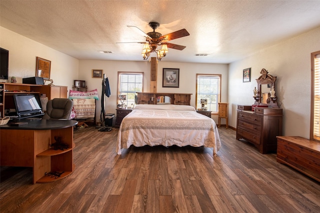 1204 County Road 122, Hico, TX 76457 - bedroom with visible vents, multiple windows, a textured ceiling, and dark wood-type flooring