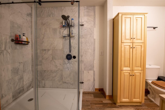 1204 County Road 122, Hico, TX 76457 - full bathroom featuring a stall shower, toilet, baseboards, and wood finished floors