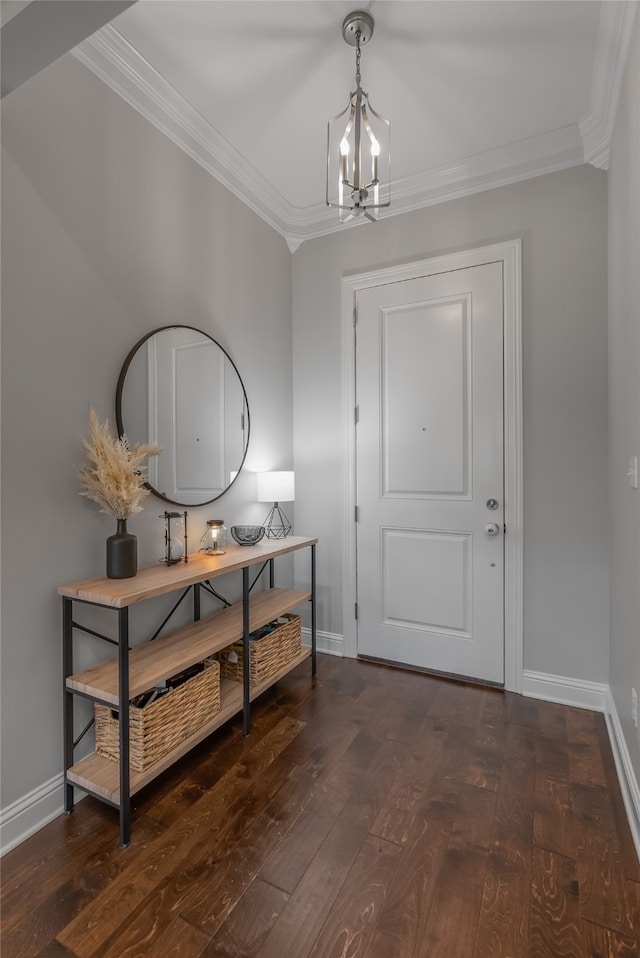 entryway featuring an inviting chandelier, dark hardwood / wood-style floors, and ornamental molding