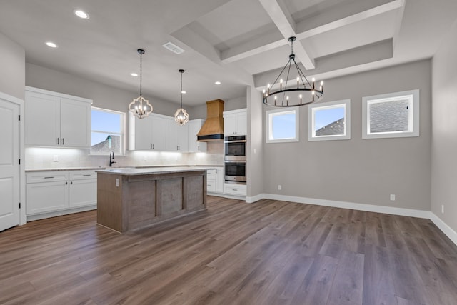 kitchen featuring wood-type flooring, a center island, and white cabinets