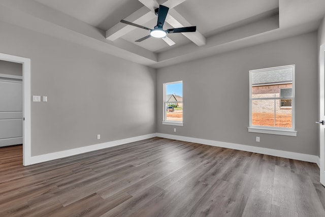 unfurnished room with ceiling fan, beam ceiling, and wood-type flooring