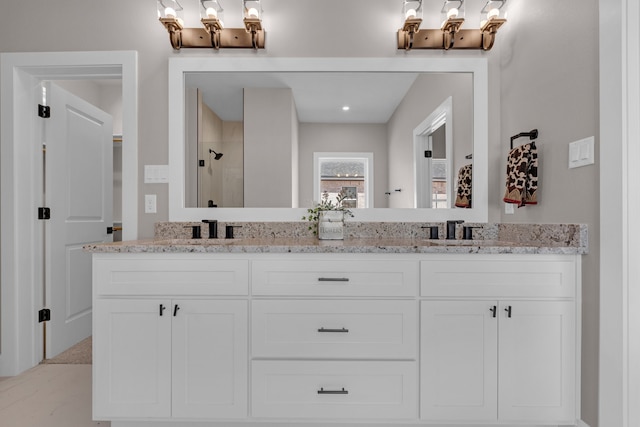 bathroom with vanity and a shower