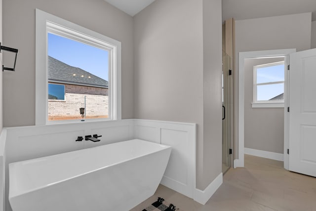 bathroom with a washtub and plenty of natural light