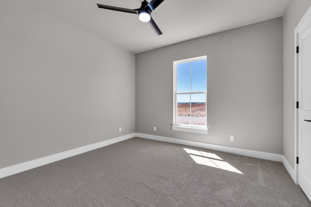 empty room featuring ceiling fan and carpet