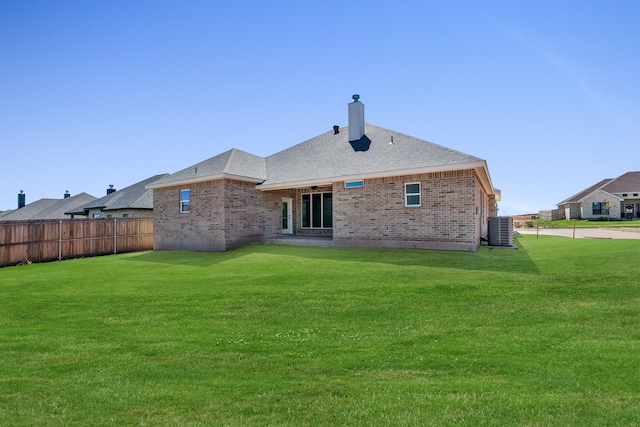 back of property with a yard, central AC unit, and a patio area