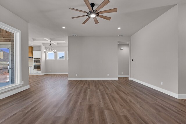 unfurnished living room with hardwood / wood-style floors and ceiling fan with notable chandelier