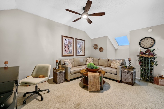 living room with light carpet, ceiling fan, and vaulted ceiling with skylight