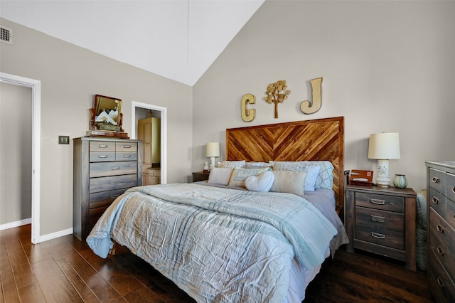 bedroom featuring dark hardwood / wood-style flooring and high vaulted ceiling