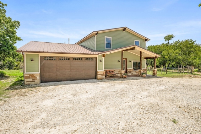 view of front of home featuring a garage and a porch