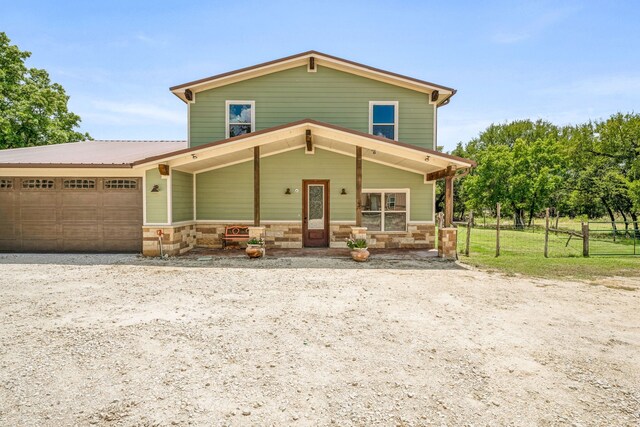 front of property featuring a garage and covered porch