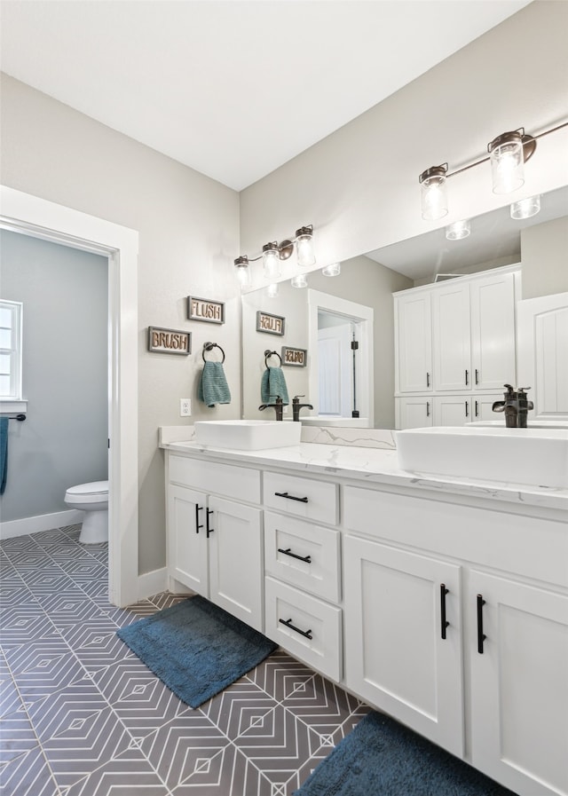 bathroom with toilet and vanity