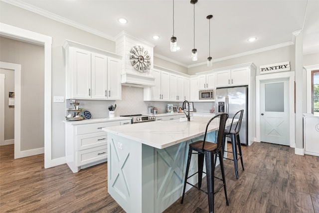 kitchen featuring dark hardwood / wood-style flooring, stainless steel appliances, white cabinetry, and a kitchen island with sink