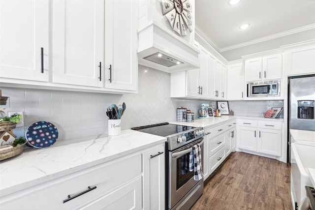 kitchen featuring white cabinets, crown molding, custom exhaust hood, stainless steel appliances, and dark wood-type flooring