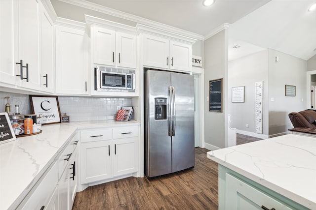 kitchen with crown molding, white cabinetry, stainless steel appliances, light stone counters, and dark wood-type flooring