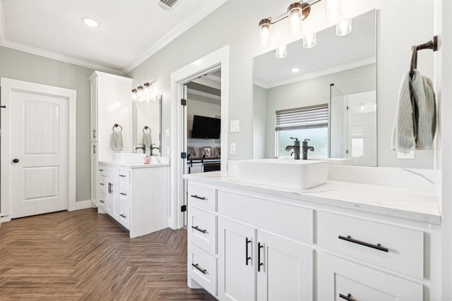 bathroom featuring crown molding, vanity, parquet flooring, and walk in shower