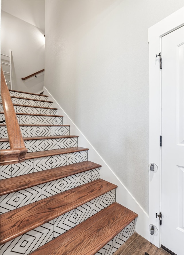 stairs featuring hardwood / wood-style flooring