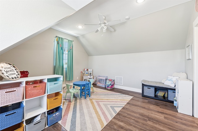 recreation room featuring lofted ceiling, ceiling fan, and dark hardwood / wood-style floors