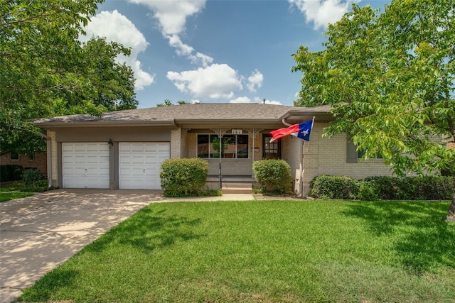 view of front of home with a garage and a front lawn