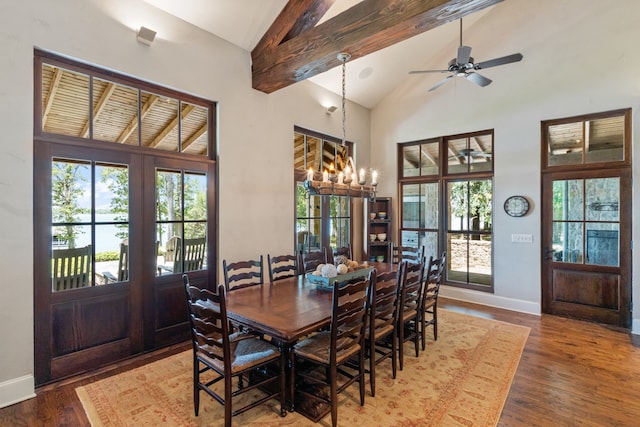 dining area featuring high vaulted ceiling, ceiling fan with notable chandelier, hardwood / wood-style floors, beam ceiling, and french doors