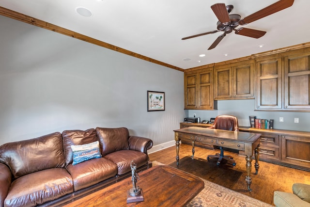 home office with hardwood / wood-style floors, crown molding, and ceiling fan