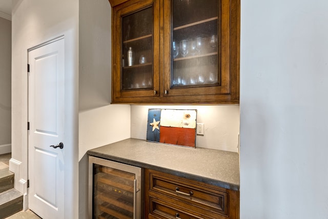 bar featuring dark brown cabinetry and beverage cooler