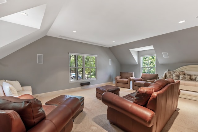 living room with plenty of natural light, lofted ceiling, and light colored carpet