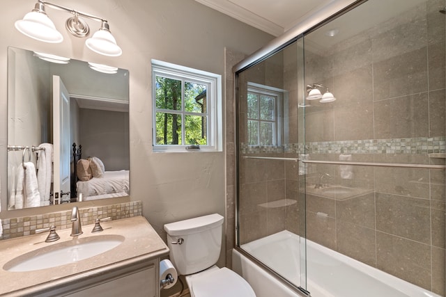 full bathroom with backsplash, toilet, bath / shower combo with glass door, vanity, and crown molding