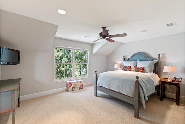 bedroom with ceiling fan, vaulted ceiling, and light colored carpet