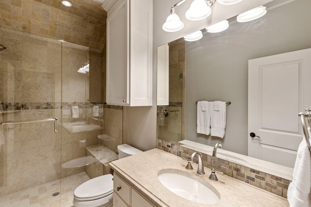 bathroom featuring tasteful backsplash, vanity, walk in shower, and toilet