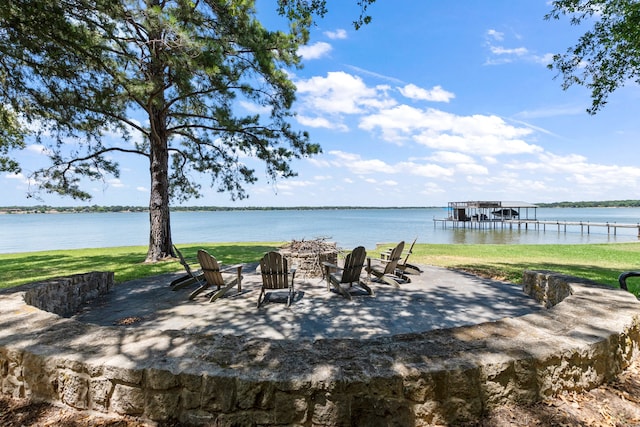 property view of water featuring a boat dock and a fire pit