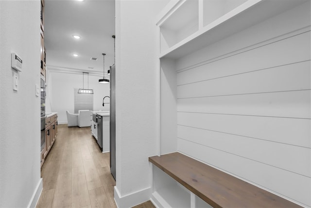 mudroom with light hardwood / wood-style flooring