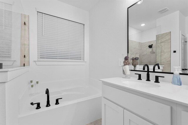 bathroom featuring vanity and shower with separate bathtub