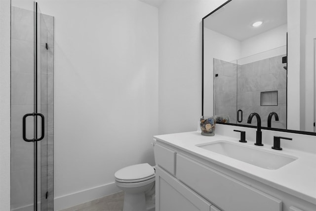 bathroom featuring walk in shower, tile patterned flooring, vanity, and toilet