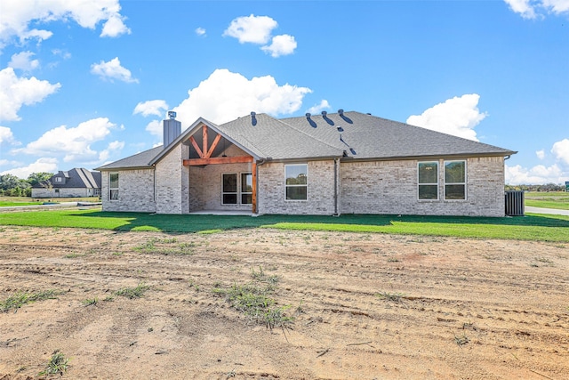 back of property featuring a lawn and a patio area