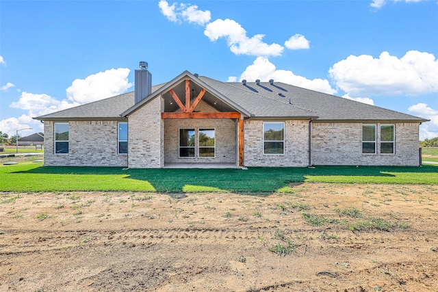 back of property with a patio and a yard