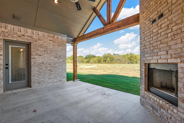 view of patio / terrace with an outdoor brick fireplace and ceiling fan