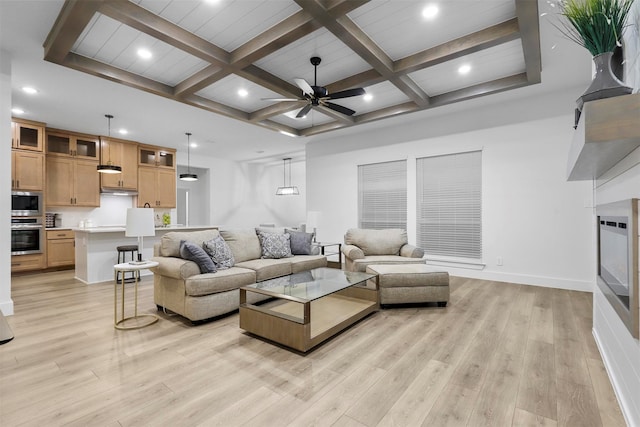 living room with ceiling fan, beam ceiling, light hardwood / wood-style flooring, and coffered ceiling