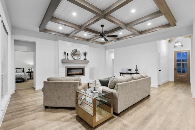 living room with ceiling fan, light hardwood / wood-style floors, beamed ceiling, and coffered ceiling