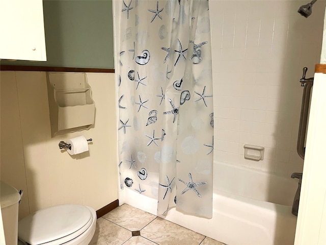 bathroom featuring toilet, shower / bath combo with shower curtain, and tile patterned floors