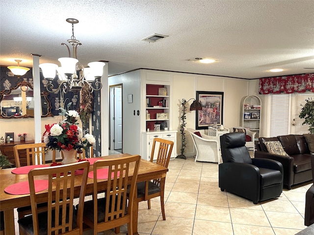 tiled dining space with built in features, a textured ceiling, and an inviting chandelier