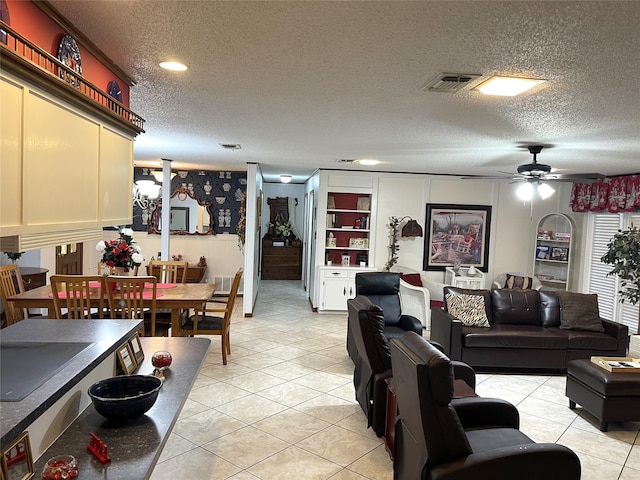 tiled living room featuring a textured ceiling and ceiling fan